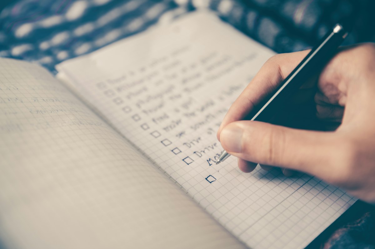 Notebook and calendar laid out for a weekly personal planning review
